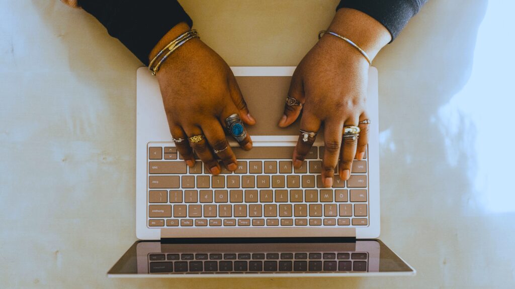 Laptop with hands on keyboard