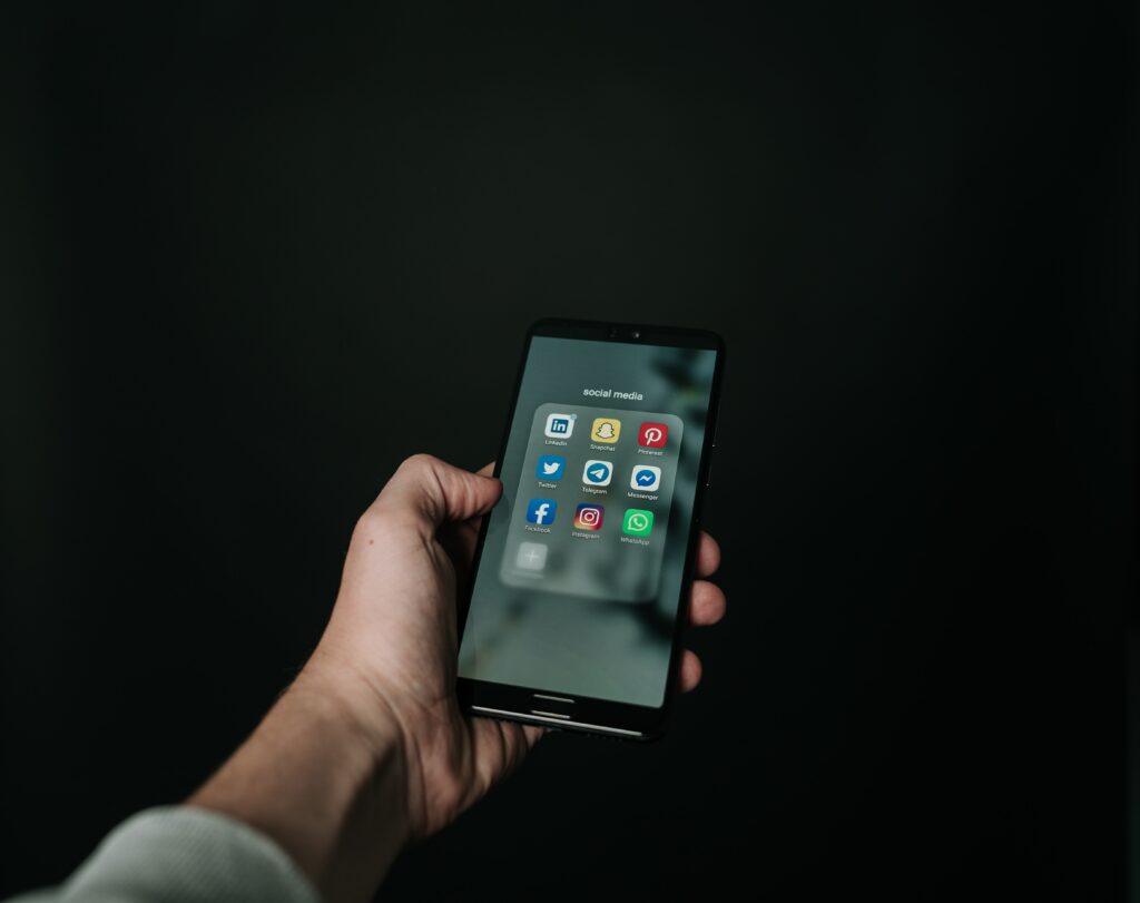 Photo of hand holding a Bblack smartphone
